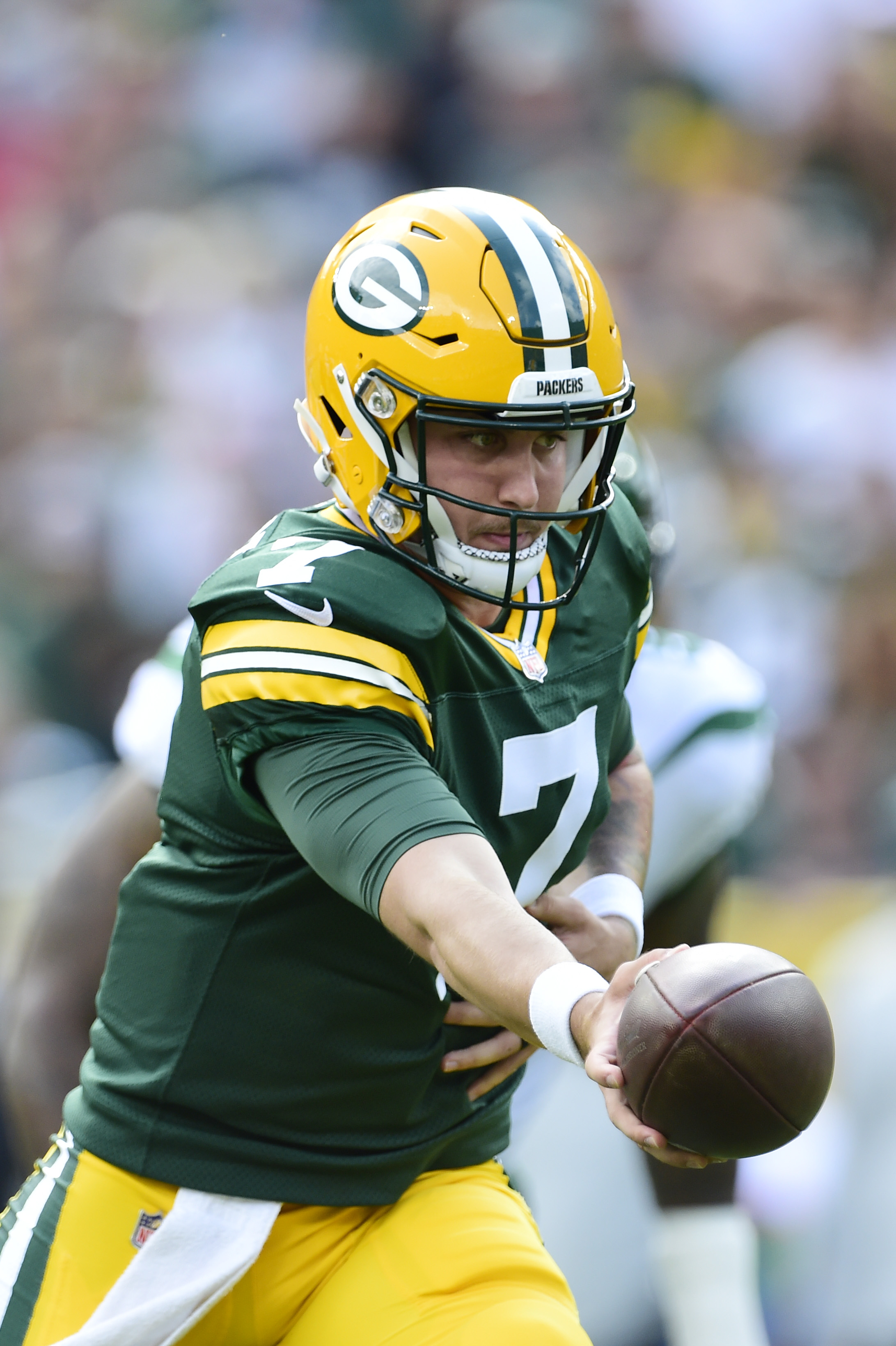 GREEN BAY, WISCONSIN - AUGUST 21: Kurt Benkert #7 of the Green Bay Packers prepares to hand off the ball against the New York Jets in the first half of a preseason game at Lambeau Field on August 21, 2021 in Green Bay, Wisconsin. (Photo by Patrick McDermott/Getty Images)