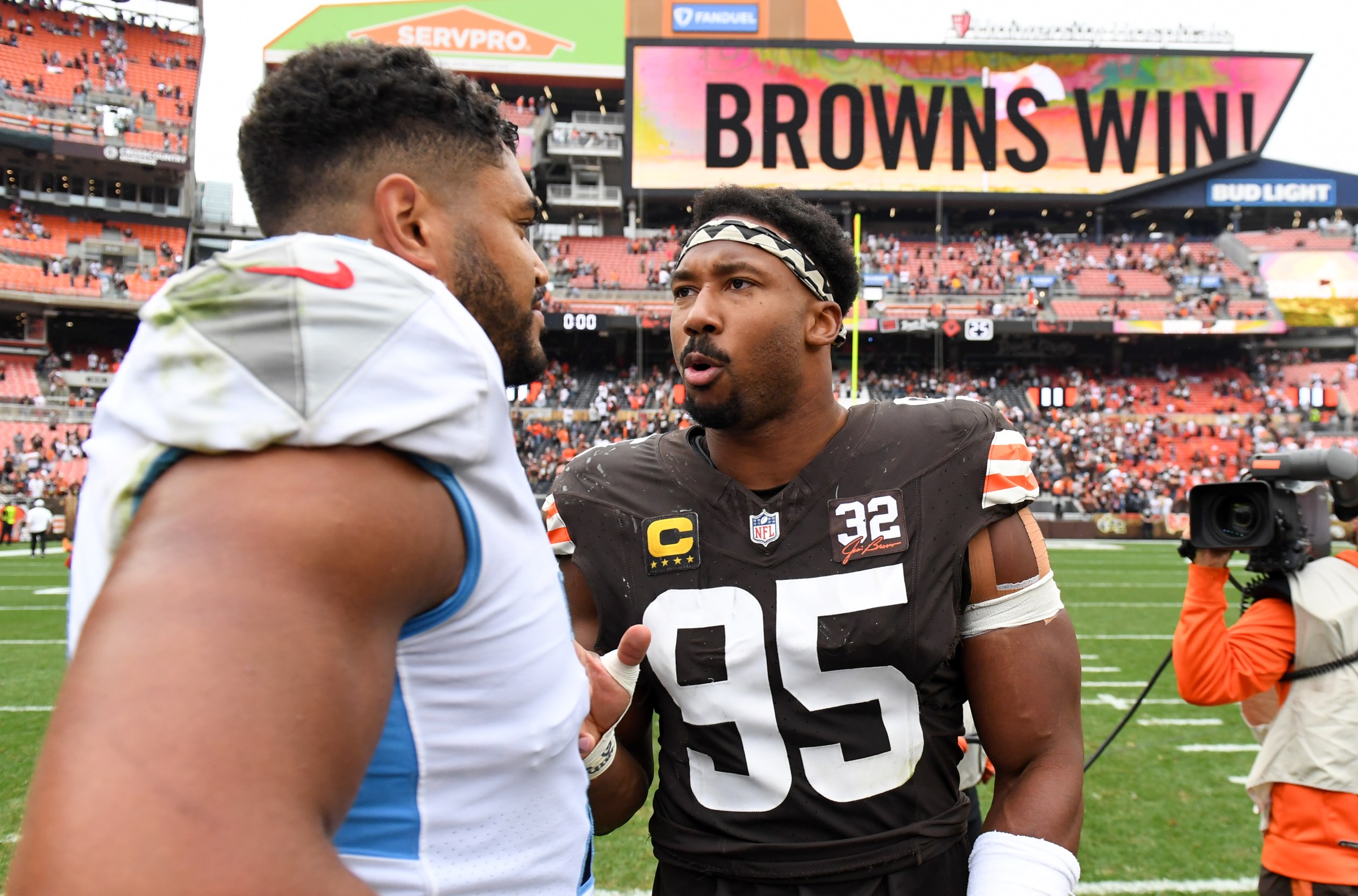 CLEVELAND, OHIO - SEPTEMBER 24: Myles Garrett #95 of the Cleveland Browns talks with Andre Dillard #71 of the Tennessee Titans after the Browns defeated the Titans 27-3 at Cleveland Browns Stadium on September 24, 2023 in Cleveland, Ohio. (Photo by Nick Cammett/Diamond Images via Getty Images)
