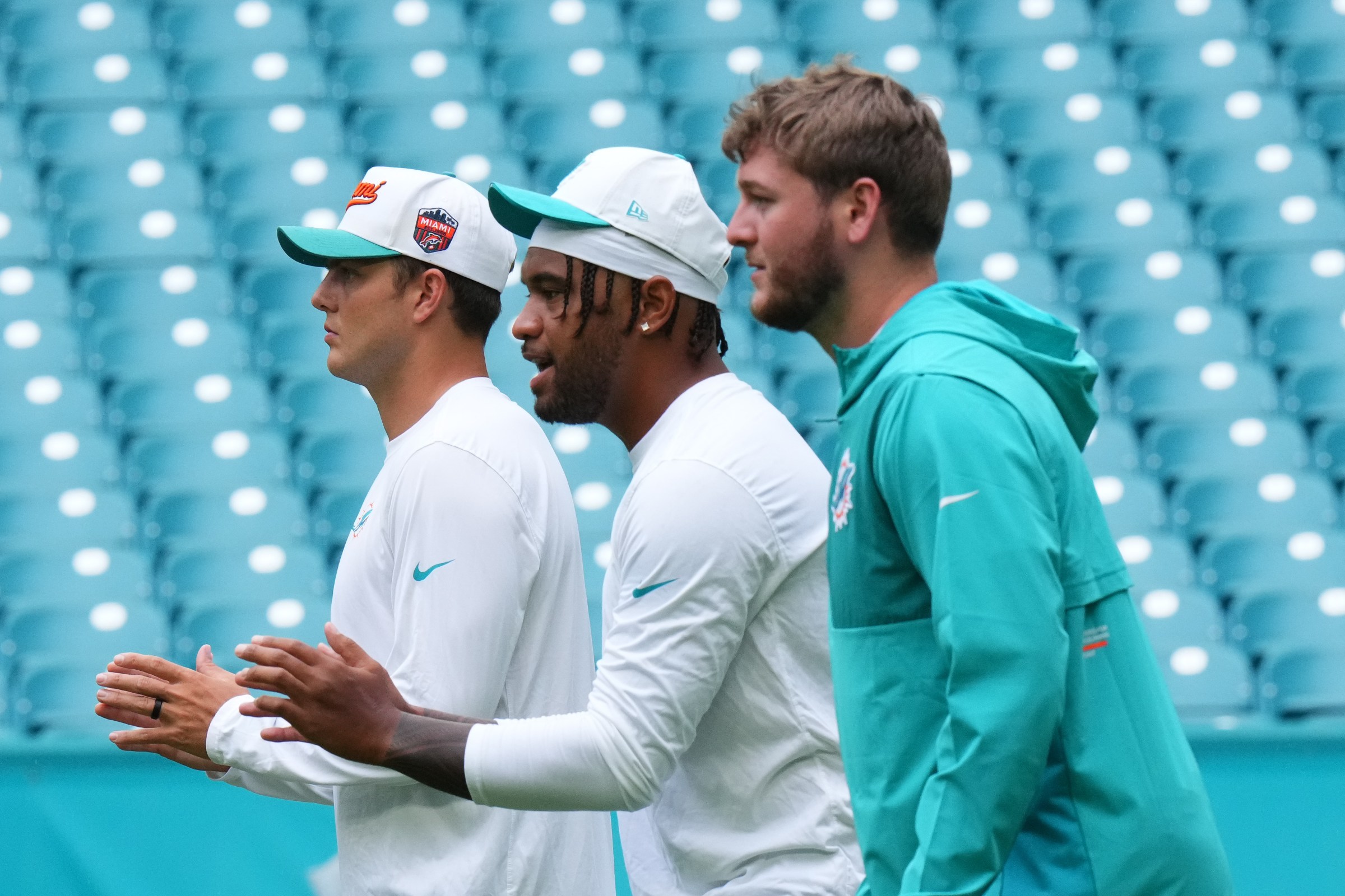 MIAMI GARDENS, FLORIDA - AUGUST 23: Zach Wilson #0, Tua Tagovailoa #1 and Quinn Ewers #14 of the Miami Dolphins warm up prior to a NFL Preseason 2025 game between Jacksonville Jaguars and Miami Dolphins at Hard Rock Stadium on August 23, 2025 in Miami Gardens, Florida. (Photo by Rich Storry/Getty Images)