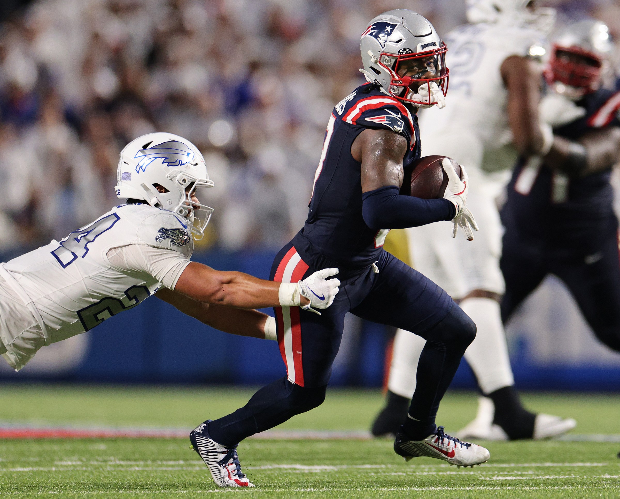ORCHARD PARK, NEW YORK - OCTOBER 05: Cole Bishop #24 of the Buffalo Bills attempts to tackle Stefon Diggs #8 of the New England Patriots in the fourth quarter of the game at Highmark Stadium on October 05, 2025 in Orchard Park, New York. (Photo by Bryan M. Bennett/Getty Images)