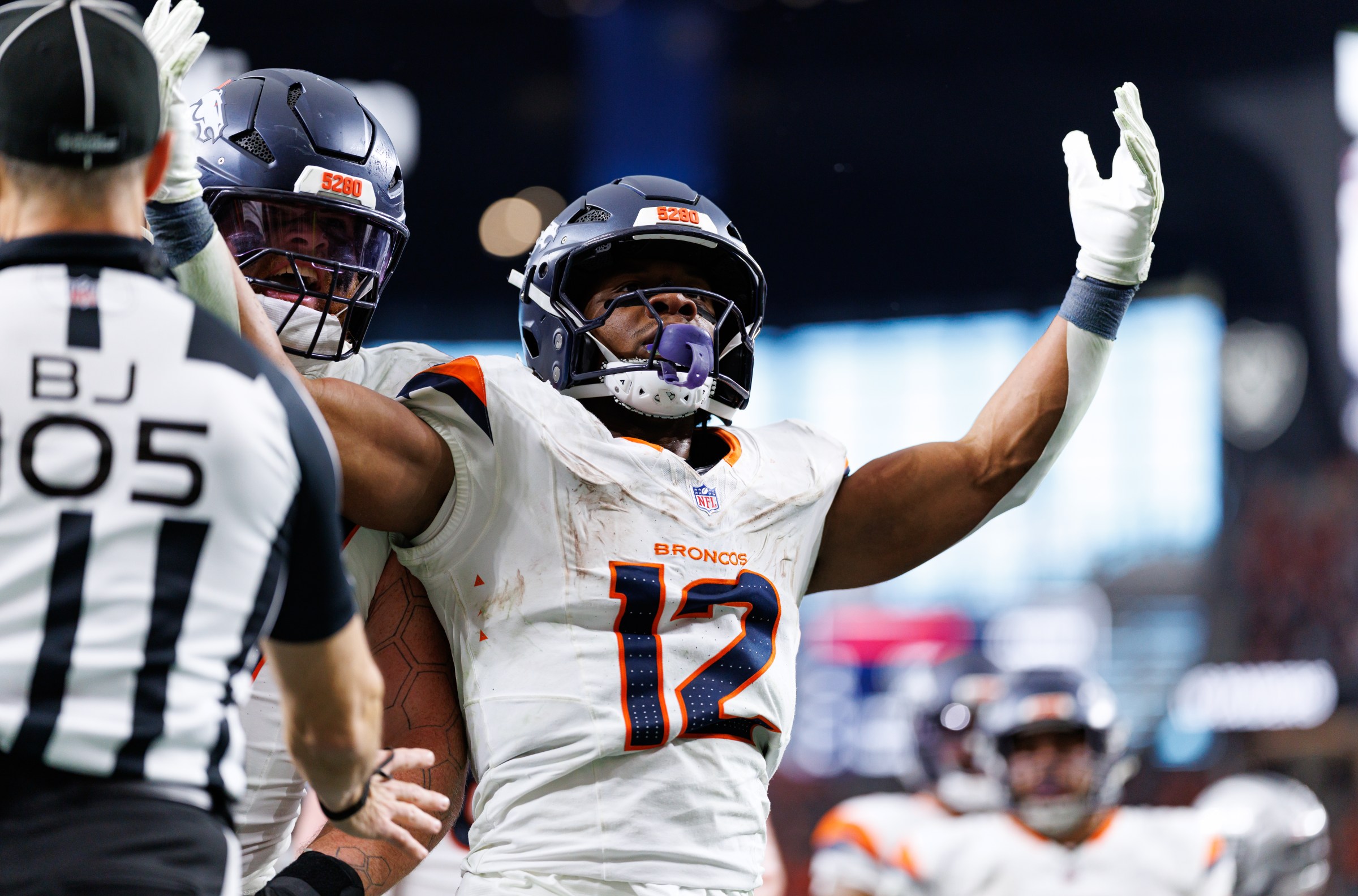 LAS VEGAS, NEVADA - DECEMBER 7: RJ Harvey #12 of the Denver Broncos celebrates with Quinn Meinerz #77 after scoring a touchdown during the third quarter of an NFL football game at Allegiant Stadium on December 07, 2025 in Las Vegas, Nevada. (Photo by Brooke Sutton/Getty Images)