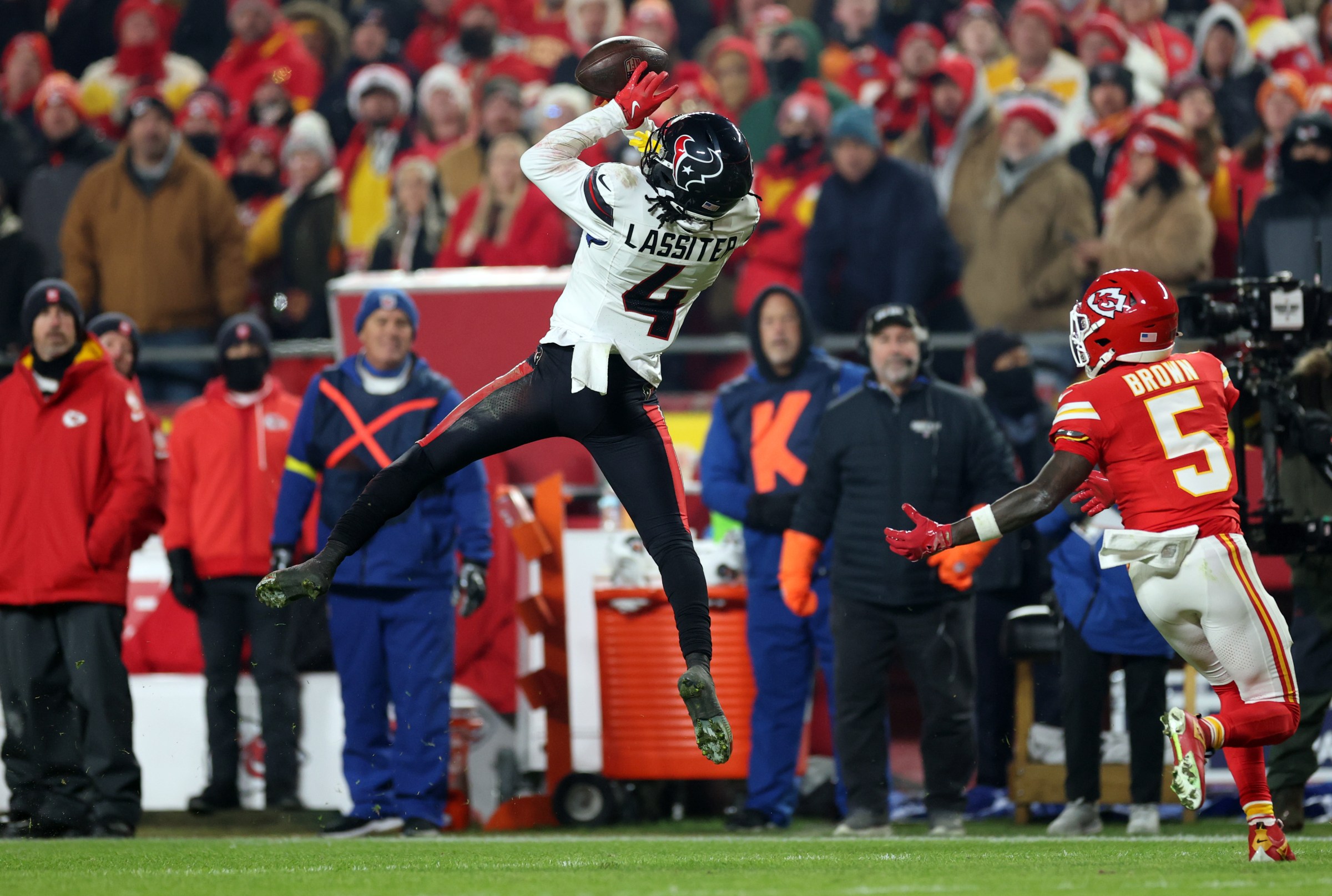 KANSAS CITY, MISSOURI - DECEMBER 07: Kamari Lassiter #4 of the Houston Texans intercepts a pass intended for Marquise Brown #5 of the Kansas City Chiefs during the fourth quarter at Arrowhead Stadium on December 07, 2025 in Kansas City, Missouri. (Photo by Jamie Squire/Getty Images)