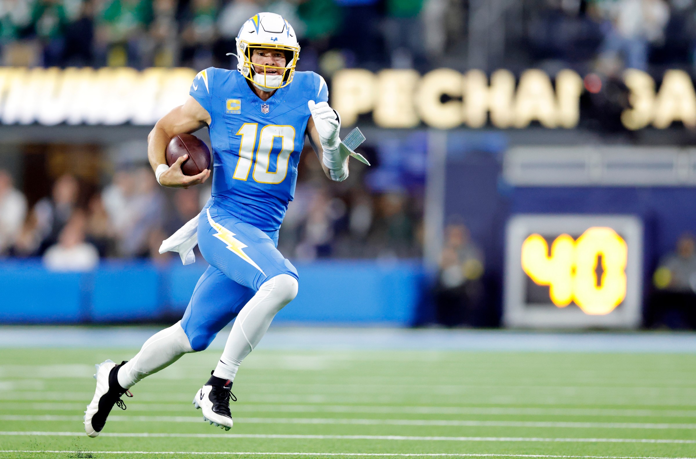 INGLEWOOD, CALIFORNIA - DECEMBER 08: Justin Herbert #10 of the Los Angeles Chargers runs with the ball during the third quarter against the Philadelphia Eagles at SoFi Stadium on December 08, 2025 in Inglewood, California. (Photo by Ronald Martinez/Getty Images)
