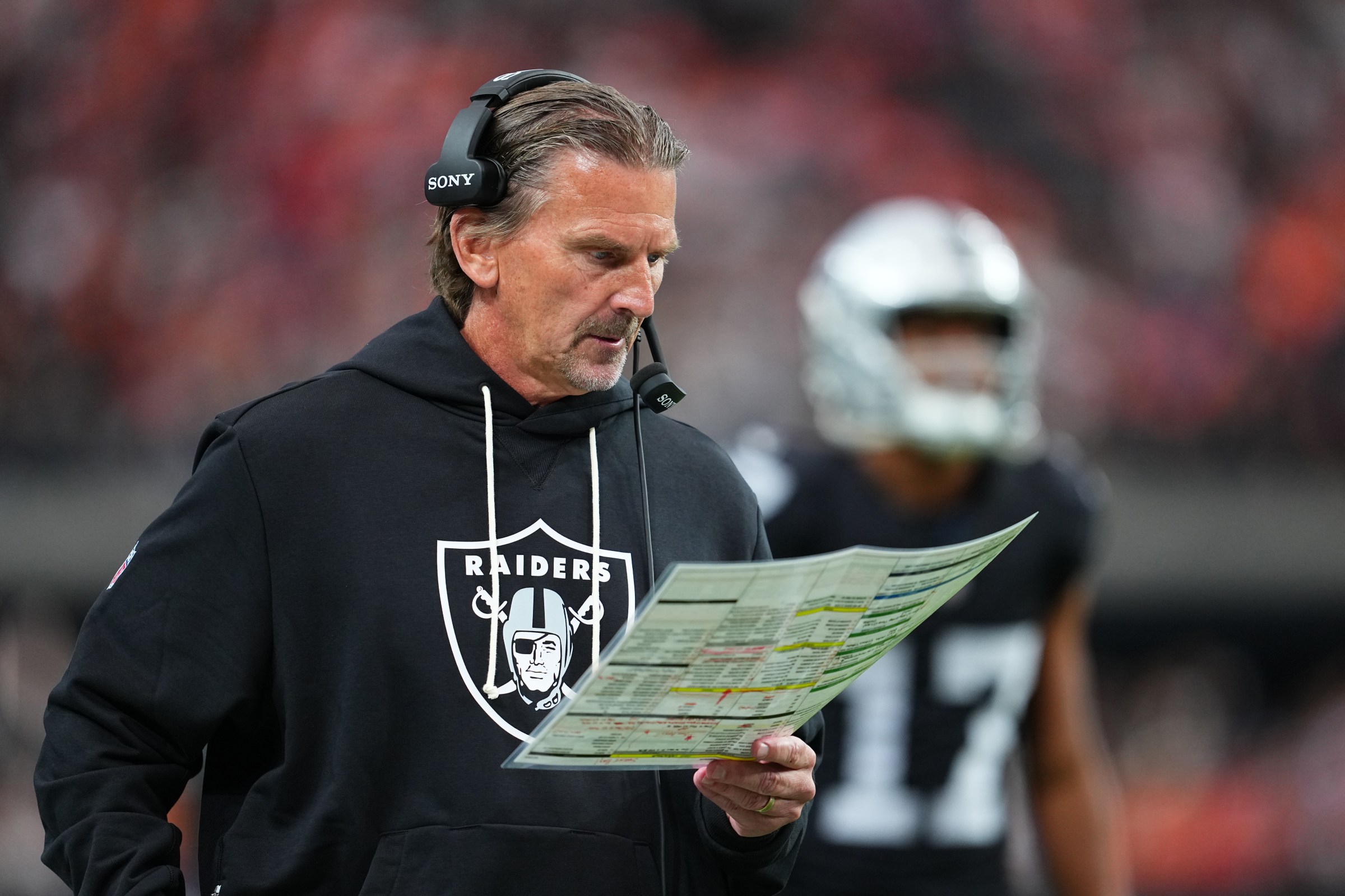 LAS VEGAS, NEVADA - DECEMBER 07: Interim offensive coordinator Greg Olson looks at his play sheet during the first half of a game against the Denver Broncos at Allegiant Stadium on December 07, 2025 in Las Vegas, Nevada. (Photo by Chris Unger/Getty Images)