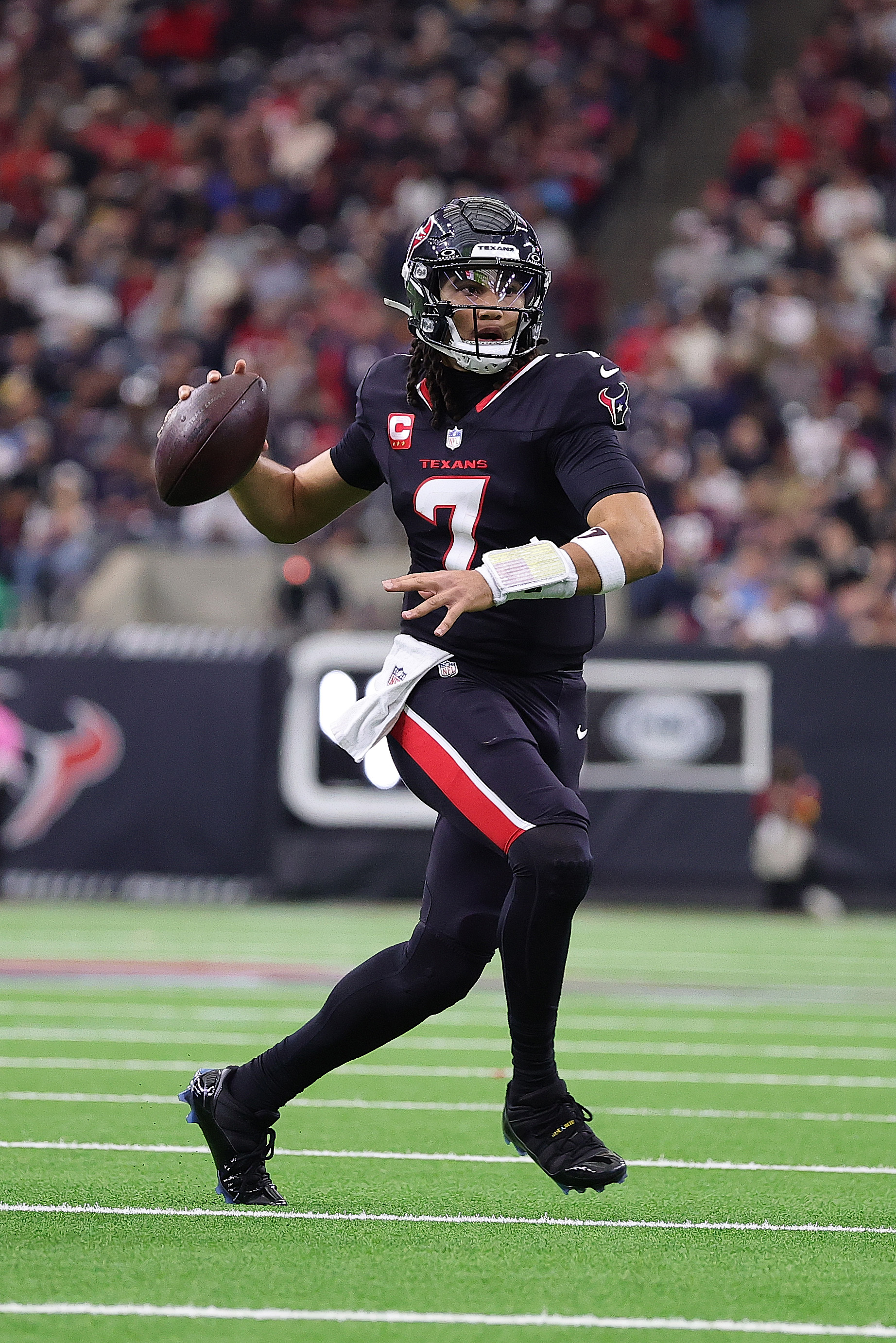 HOUSTON, TEXAS - DECEMBER 14: C.J. Stroud #7 of the Houston Texans scrambles during the second quarter against the Arizona Cardinals at NRG Stadium on December 14, 2025 in Houston, Texas. (Photo by Alex Slitz/Getty Images)