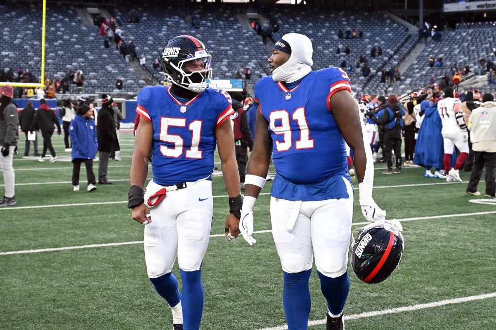 Giants linebacker Abdul Carter (51) and defensive tackle Darius Alexander (91) walk off the field.