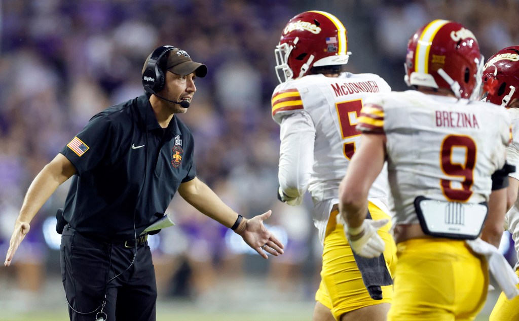 Iowa State Cyclones head coach Matt Campbell celebrating with players.