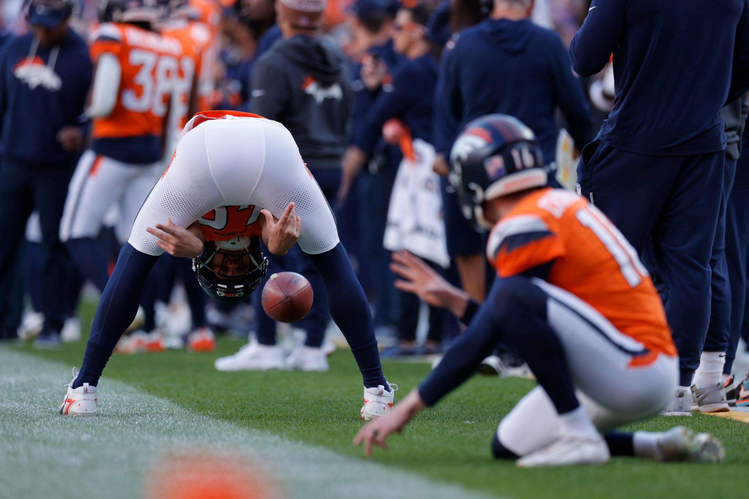 Dec 14, 2025; Denver, Colorado, USA; Denver Broncos long snapper Mitchell Fraboni (48) snaps the ball to punter Jeremy Crawshaw (16) on the sidelines during the second quarter against the Green Bay Packers at Empower Field at Mile High. Mandatory Credit: Isaiah J. Downing-Imagn Images