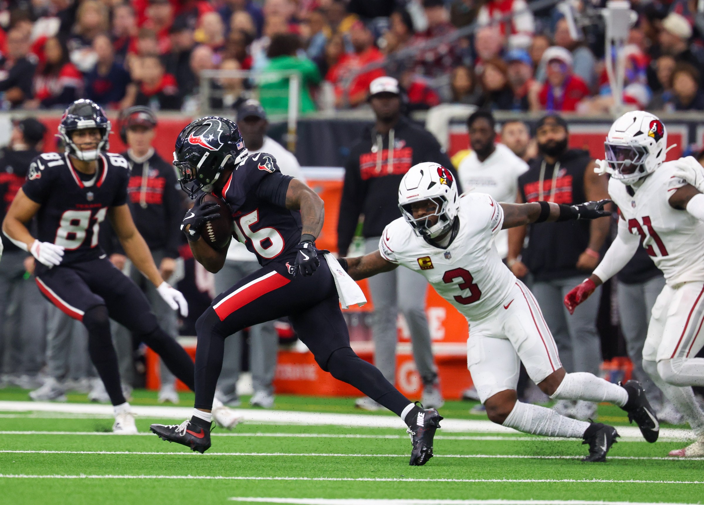 Dec 14, 2025; Houston, Texas, USA; Houston Texans running back Jawhar Jordan (26) rushes against Arizona Cardinals safety Budda Baker (3) in the third quarter at NRG Stadium. Mandatory Credit: Thomas Shea-Imagn Images