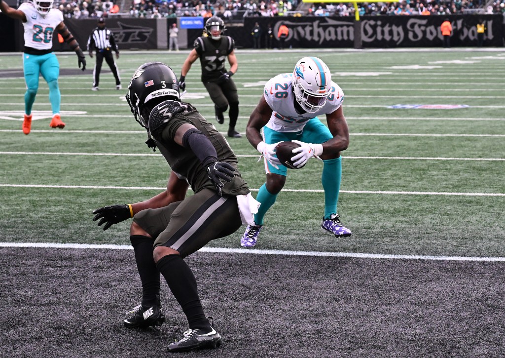 Dolphins cornerback Rasul Douglas (26) intercepts a ball intended for Jets wide receiver John Metchie III (3) in the end zone.