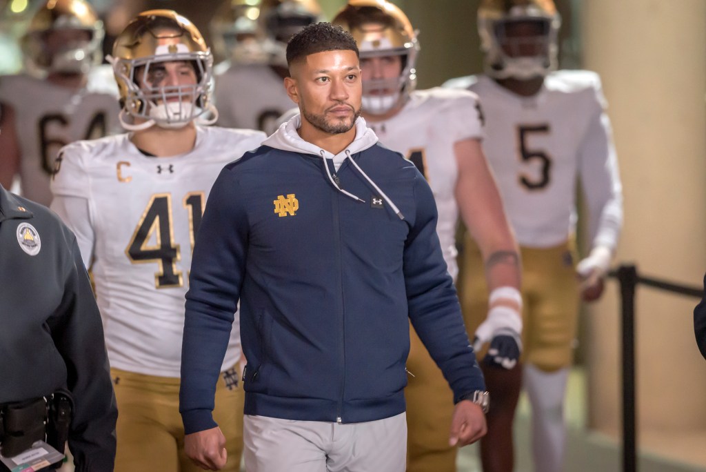 Head Coach Marcus Freeman of the Notre Dame Fighting Irish leads his team into the stadium to start the second half of a college football game against the Stanford Cardinal on November 29, 2025 at Stanford Stadium in Palo Alto, California.   