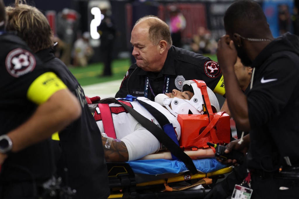 Medical personnel treat Arizona Cardinals wide receiver Andre Baccellia (82) following an injury on a kickoff return against the Texans.