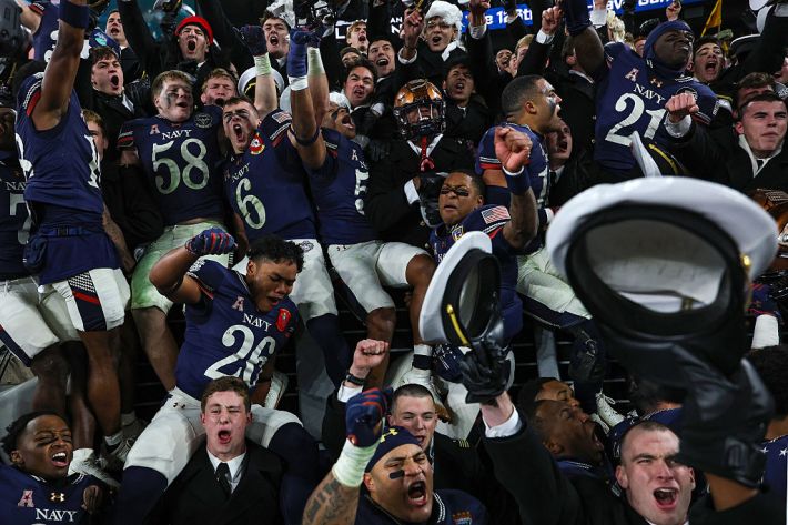 BALTIMORE, MARYLAND - DECEMBER 13: The Navy Midshipmen celebrate with fans after defeating the Army Black Knights, 17-16, in the 126th America's Game between the Army Black Knights and the Navy Midshipmen at M&T Bank Stadium on December 13, 2025 in Baltimore, Maryland.