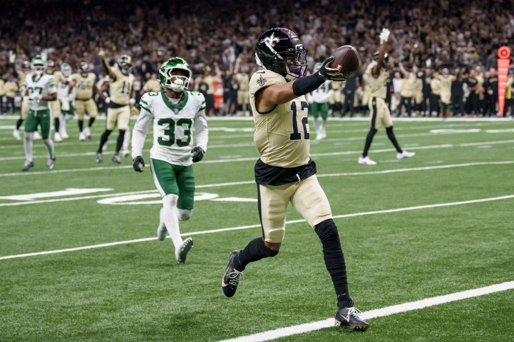 New Orleans Saints wide receiver Chris Olave (12) crosses the goal line for a touchdown against New York Jets cornerback Jordan Clark (33).