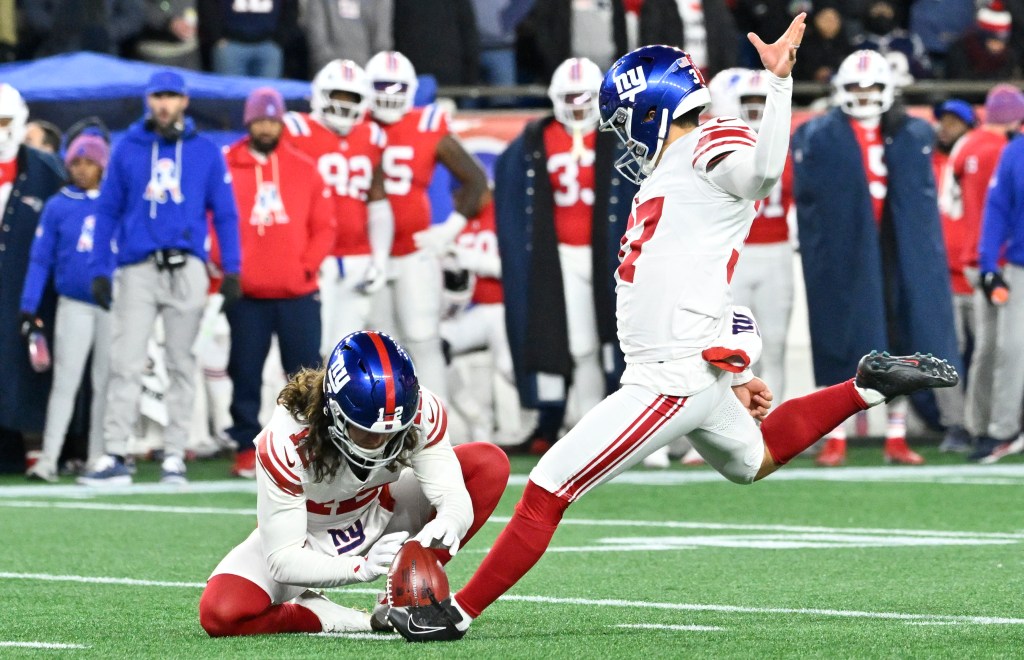 New York Giants place kicker Younghoe Koo (37) kicking an extra point with teammate Jamie Gillan (12) holding the ball.Giants place kicker Younghoe Koo (37) makes an extra point during the second quarter against the New England Patriots