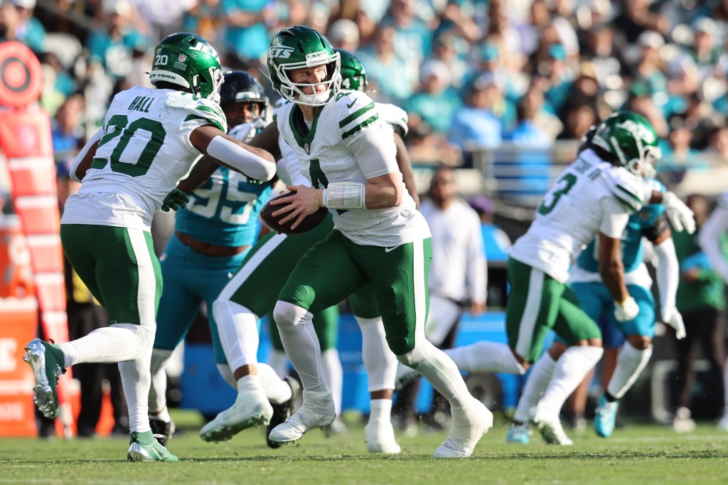 New York Jets quarterback Brady Cook (4) looks to pass the ball against the Jacksonville Jaguars during the third quarter at EverBank Stadium.