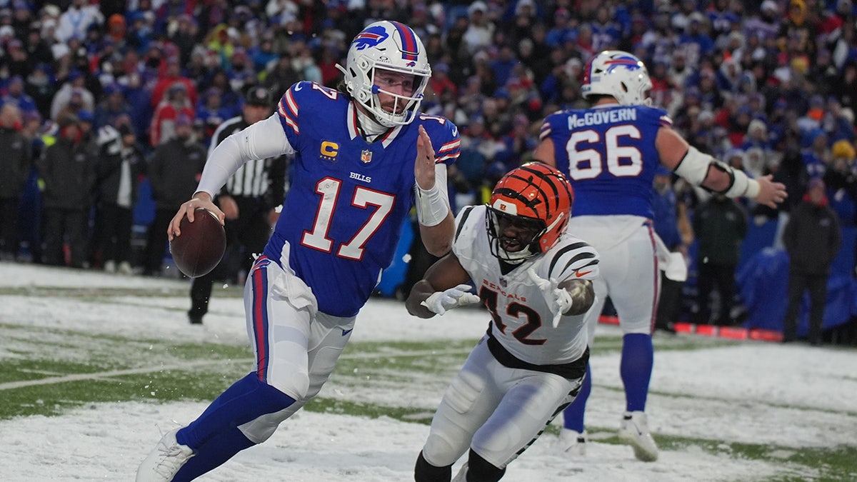 Buffalo Bills quarterback Josh Allen (17) scrambles away from Cincinnati Bengals linebacker Oren Burks (42) during the second half of an NFL football game, Sunday, Dec. 7, 2025, in Orchard Park, New York.
