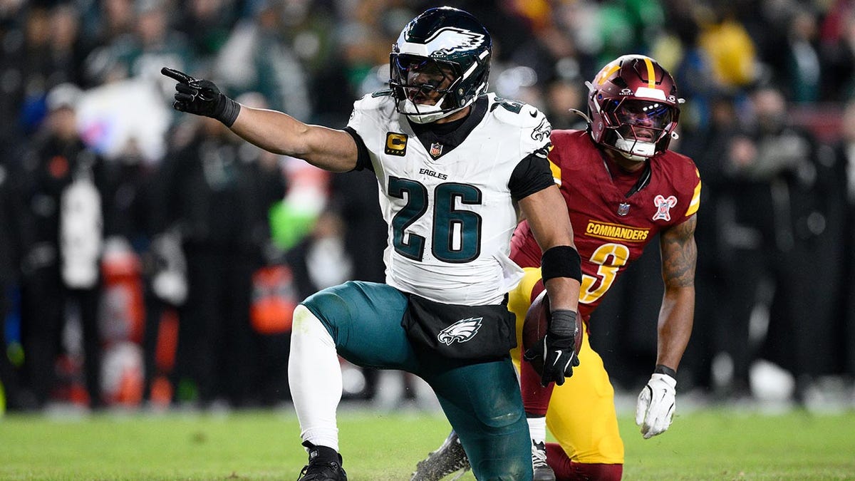 Saquon Barkley points to the first down marker
