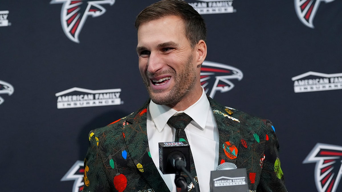 Kirk Cousins wears a Christmas suit
