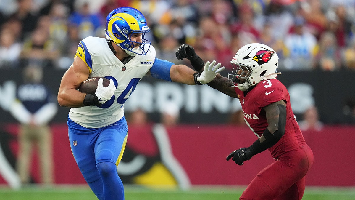 Colby Parkinson stiff arms a defender