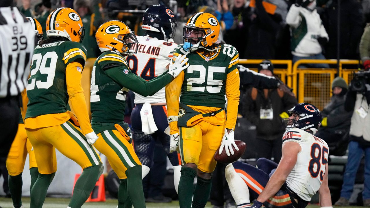 Green Bay Packers cornerback Keisean Nixon (25) celebrates after an interception against Chicago Bears tight end Cole Kmet (85) during the second half of an NFL football game Sunday, Dec. 7, 2025, in Green Bay, Wis.