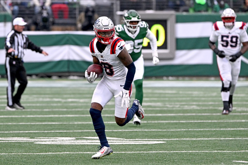 Patriots wide receiver Stefon Diggs (8) runs with the ball on the field.