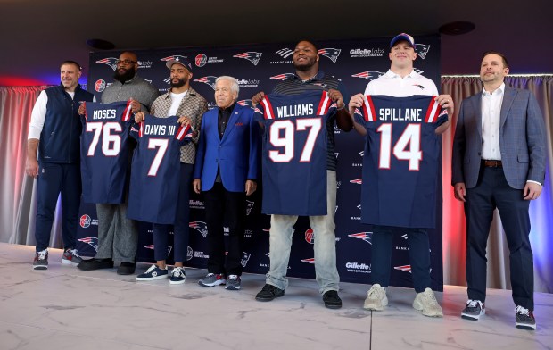 Attending Thursday's press conference in Foxboro were, from left, head coach Mike Vrabel, Morgan Moses, Carlton Davis III, owner Robert Kraft, Milton Williams, Robert Spillane and VP of player personnel Eliot Wolf. (Photo By Matt Stone/Boston Herald)