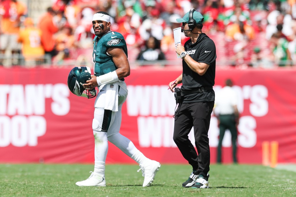 Philadelphia Eagles offensive coach Kevin Patullo communicates with quarterback Jalen Hurts during a timeout.