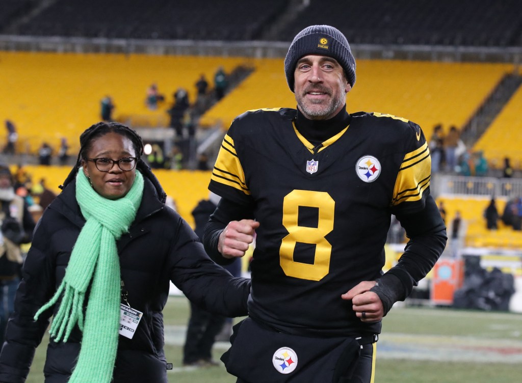 Pittsburgh Steelers quarterback Aaron Rodgers (8) running off the field after a game.