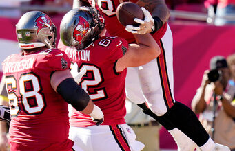 Tampa Bay Buccaneers offensive tackle Tristan Wirfs (78) celebrates his touchdown catch against the Arizona Cardinals with Buccaneers center Graham Barton (62) and Buccaneers guard Ben Bredeson (68) during the first half of an NFL football game Sunday, Nov. 30, 2025, in Tampa, Fla. (AP Photo/Chris O