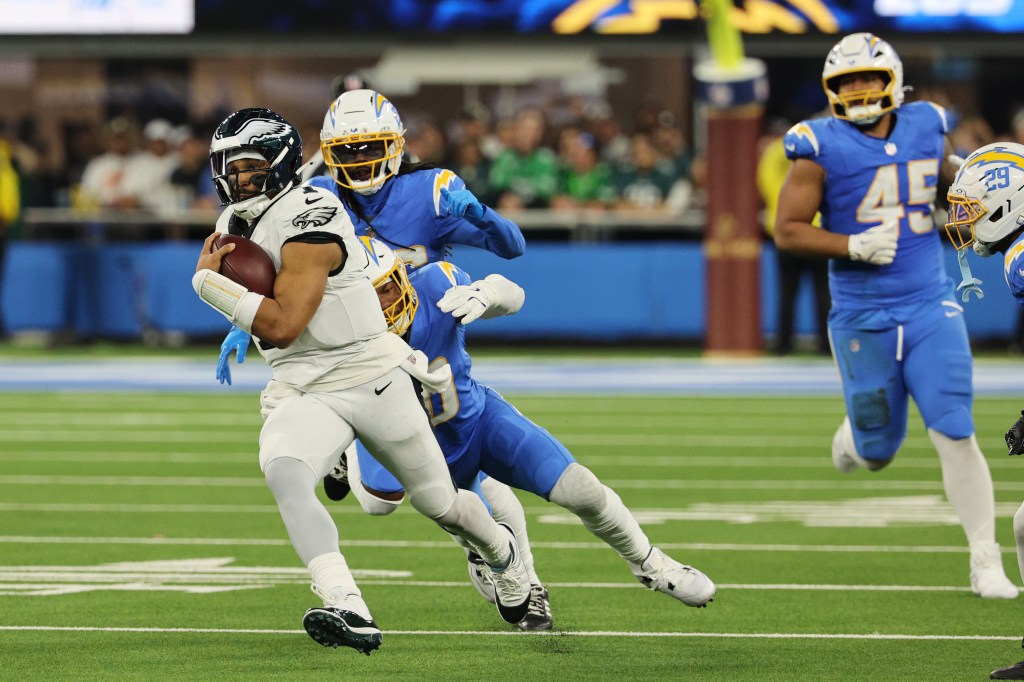 Jalen Hurts running with the football during overtime of an NFL game against the Los Angeles Chargers.