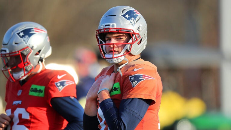 The NE Patriots practiced on their practice field at Gillette Stadium. QB Drake Maye walks along the field during stretching.