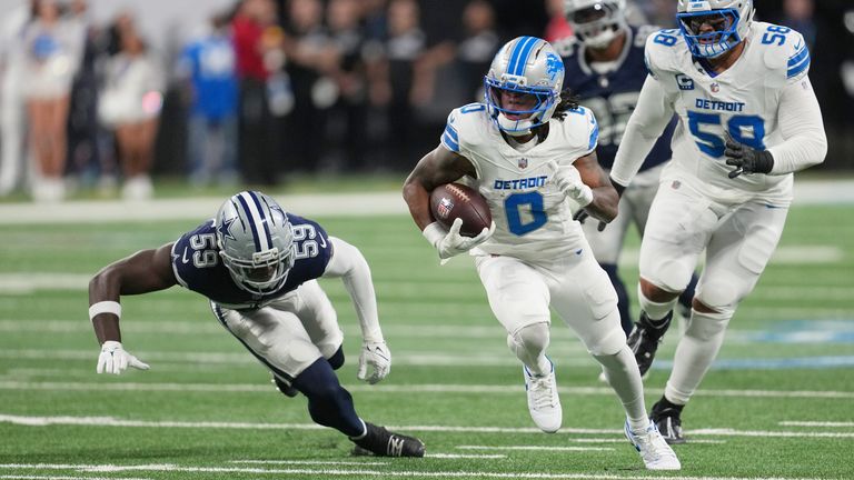 Detroit Lions running back Jahmyr Gibbs (0) runs the ball as Dallas Cowboys linebacker Jr. Kenneth Murray (59) tries to stop him during the first half of an NFL football game Thursday, Dec. 4, 2025, in Detroit. (AP Photo/Paul Sancya)