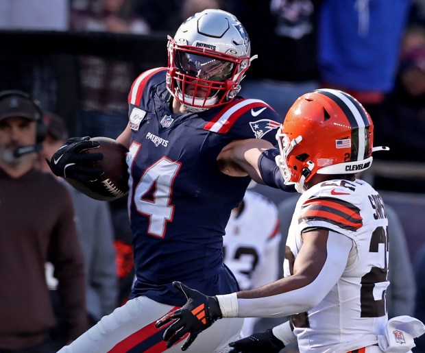 New England Patriots linebacker Robert Spillane stiff-arms Cleveland Browns running back Dylan Sampson after an interception during a game at Gillette Stadium. (Nancy Lane/Boston Herald)