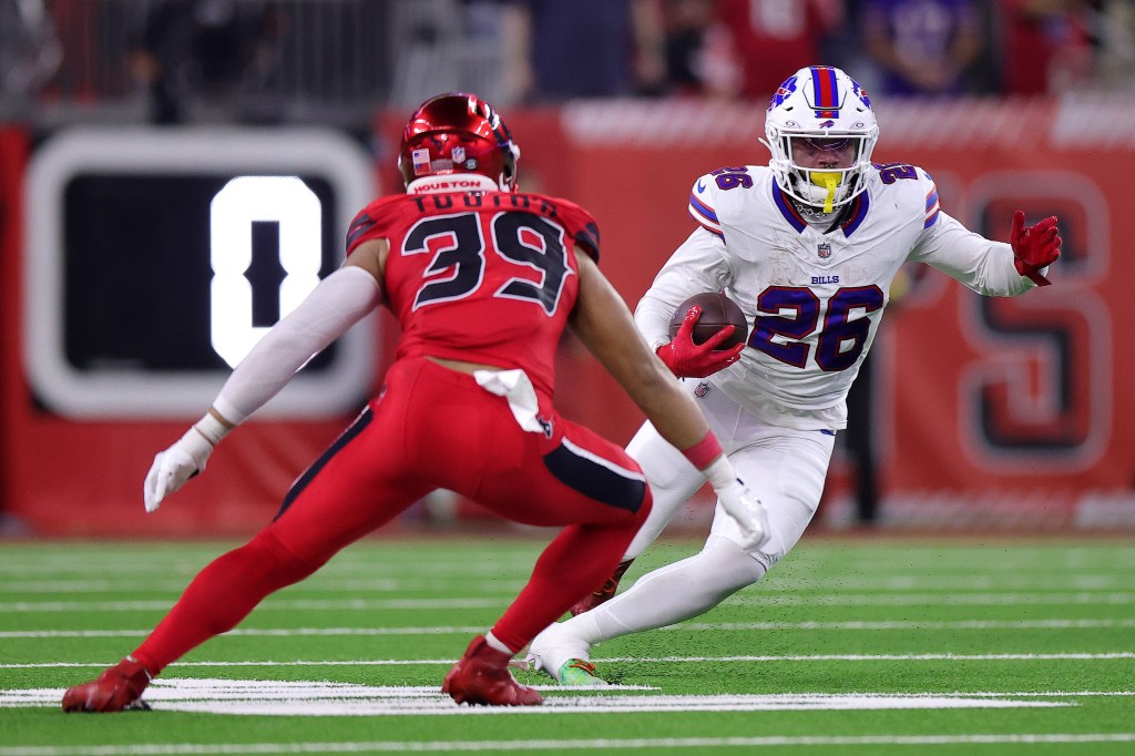 Ty Johnson of the Buffalo Bills carries the ball against Henry To'oTo'o of the Houston Texans.