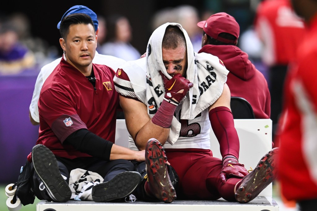 Washington Commanders tight end Zach Ertz (86) is carted off the field after an injury during the second half against the Vikinings at U.S. Bank Stadium in Minnesota on December 7, 2025. 