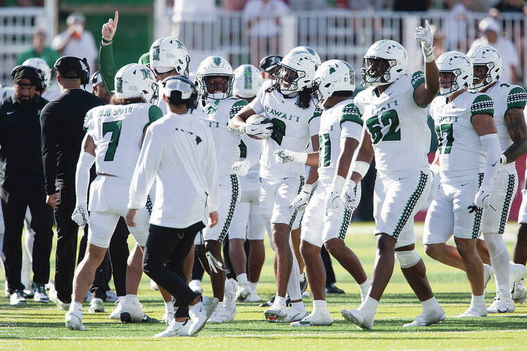 UH player passes on commencement to join football practice