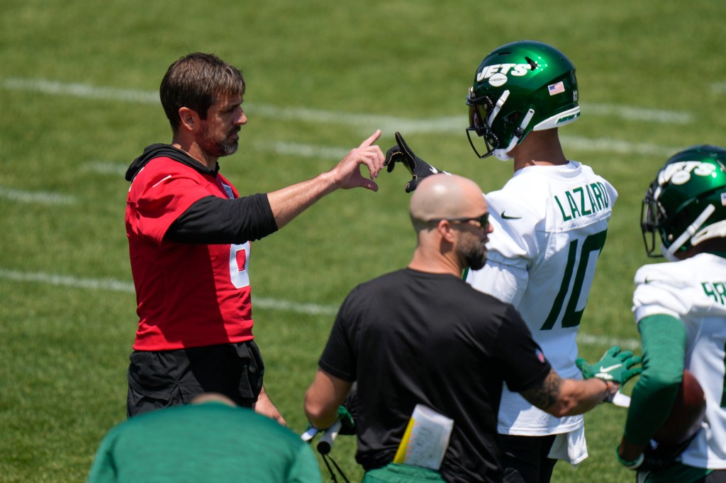 Aaron Rodgers greets Allen Lazard during NFL football practice.