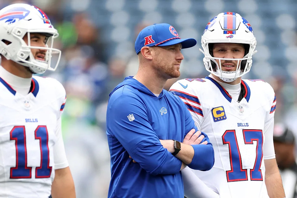 SEATTLE, WASHINGTON - OCTOBER 27: Offensive coordinator Joe Brady stands with Mitchell Trubisky #11 and Josh Allen #17 of the Buffalo Bills before the game against the Seattle Seahawks at Lumen Field on October 27, 2024 in Seattle, Washington.