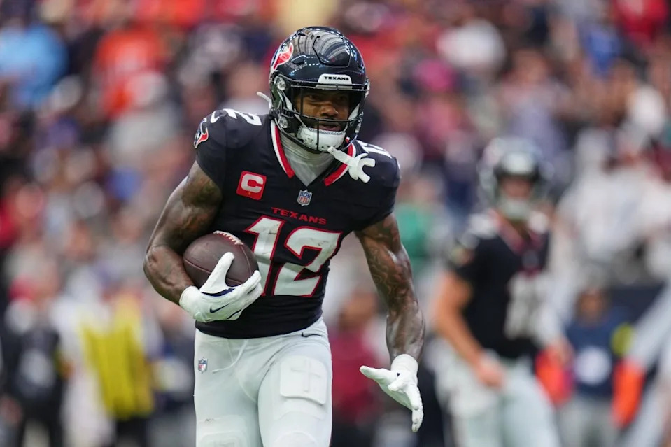 Houston Texans wide receiver Nico Collins (12) gains yards as he carries the ball in the first half of an NFL football game against the Denver Broncos Sunday, Nov. 2, 2025, in Houston. AP