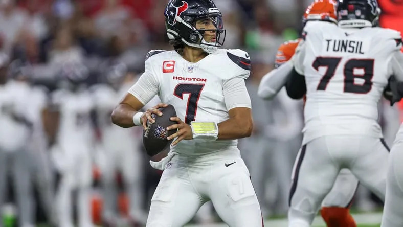 C.J. Stroud throwing during a Texans game at NRG Stadium.