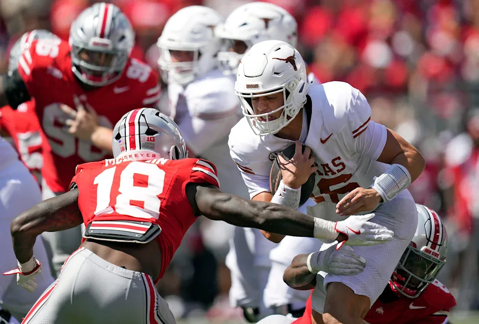 Ohio State Buckeyes safety Jaylen McClain (18) tries to tackle Texas Longhorns quarterback Arch Manning (16) in the fourth quarter of their game at Ohio Stadium in Columbus, Ohio on Aug 30, 2025.