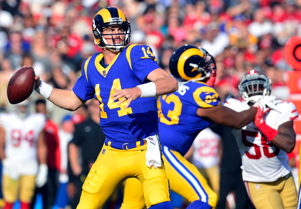 Los Angeles Rams quarterback Sean Mannion (14) throws as offensive tackle Darrell Williams (63) blocks San Francisco 49ers doutside linebacker Reuben Foster (56) during the first half at Los Angeles Memorial Coliseum.