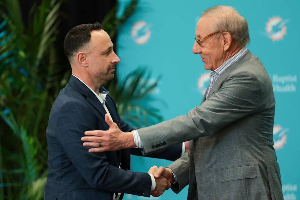 Jan 22, 2026; Miami Gardens, FL, USA; Miami Dolphins owner Stephen Ross shake hands with general manager Jon-Eric Sullivan during his introductory press conference at Baptist Health Training Complex. Sam Navarro-Imagn Images