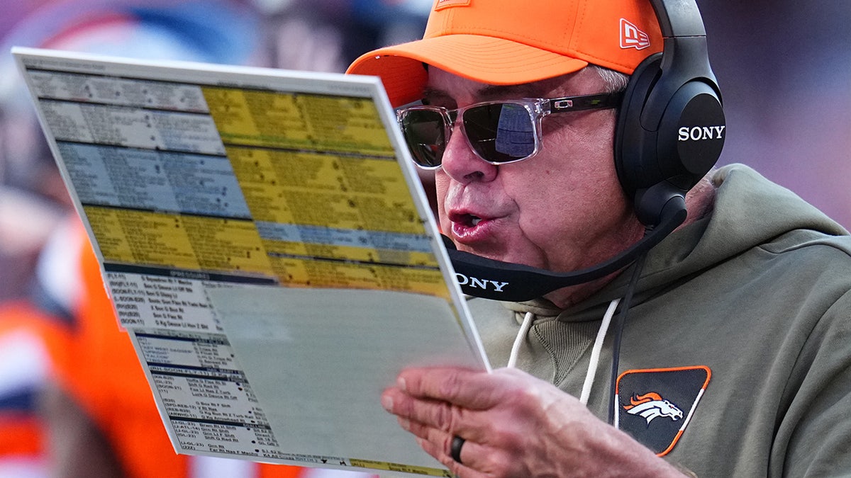 Sean Payton trying to find a play on his play sheet