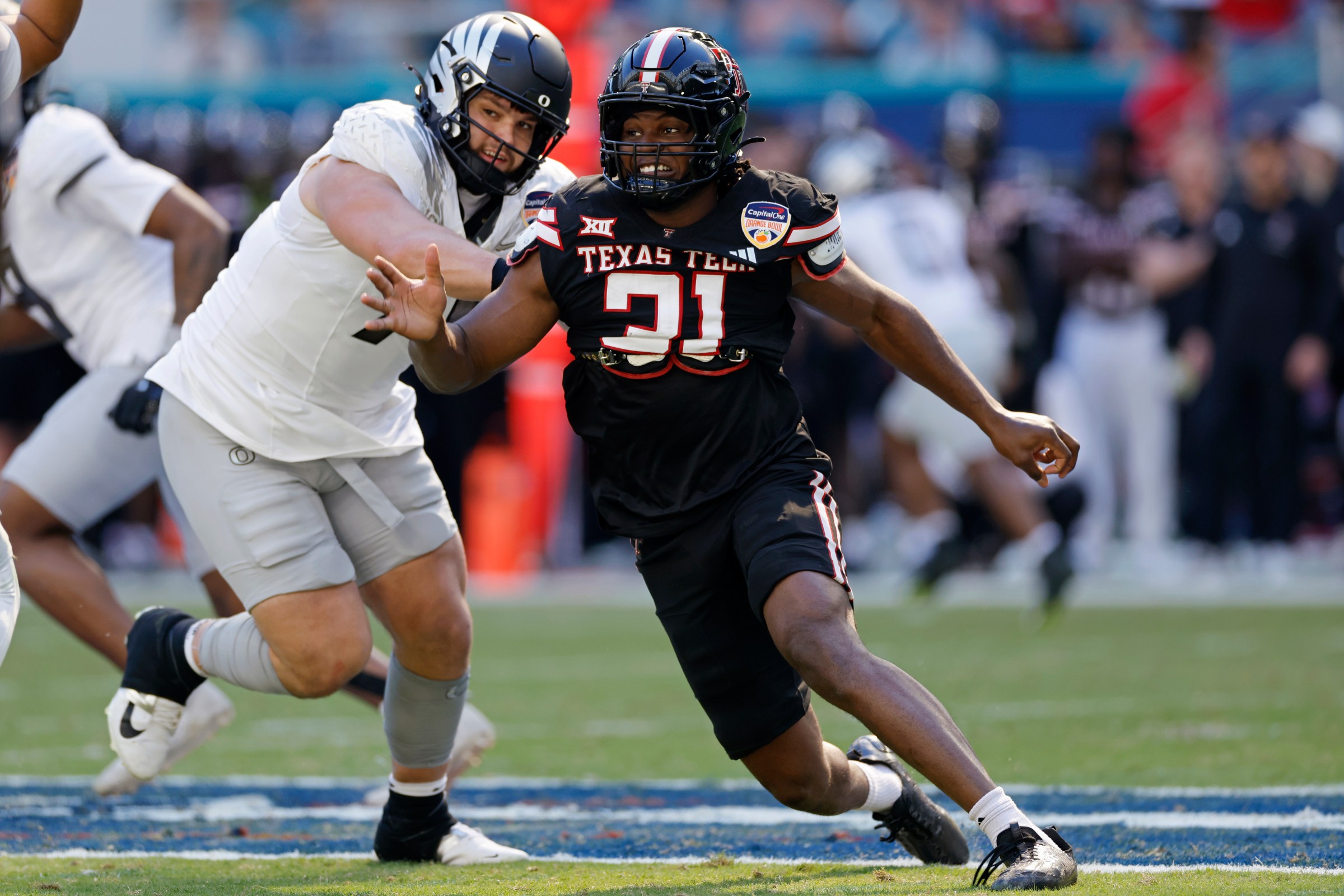 MIAMI GARDENS, FL - JANUARY 01: David Bailey #31 of the Texas Tech Red Raiders rushes on defense against Alex Harkey #71 of the Oregon Ducks during the College Football Playoff Quarterfinal at the Capital One Orange Bowl on January 01, 2026 at Hard Rock Stadium in Miami Gardens, Florida. (Photo by Joe Robbins/Icon Sportswire via Getty Images)