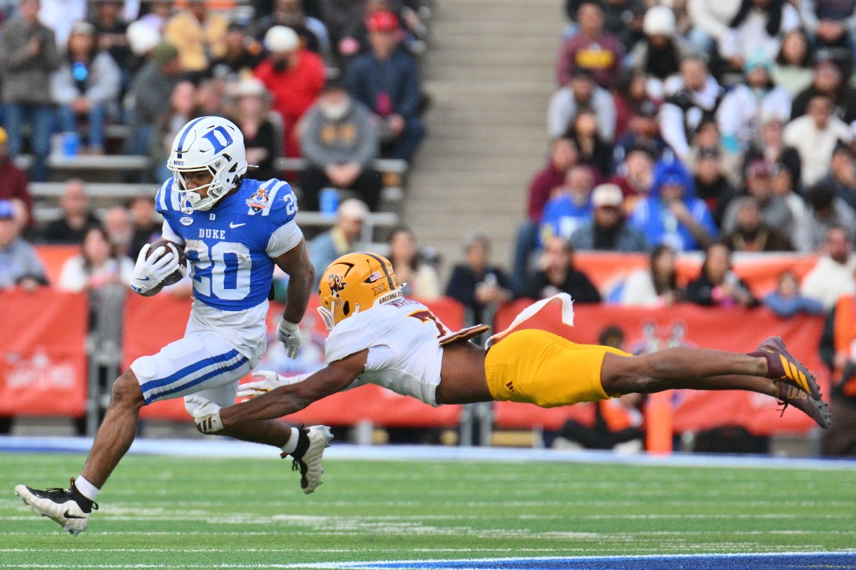 Running back Nate Sheppard #20 of the Duke Blue Devils escapes a diving tackle attempt from defensive back Montana Warren #7 of the Arizona State Sun Devils during the second half of the Tony The Tiger Sun Bowl game at Sun Bowl Stadium on December 31, 2025 in El Paso, Texas. The Blue Devils defeated the Sun Devils 42-39.