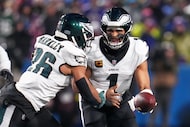 Philadelphia Eagles quarterback Jalen Hurts (1) hands off to running back Saquon Barkley...
