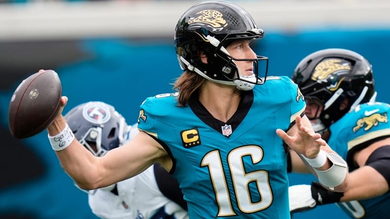 Jacksonville Jaguars quarterback Trevor Lawrence (16) looks to throw a...
