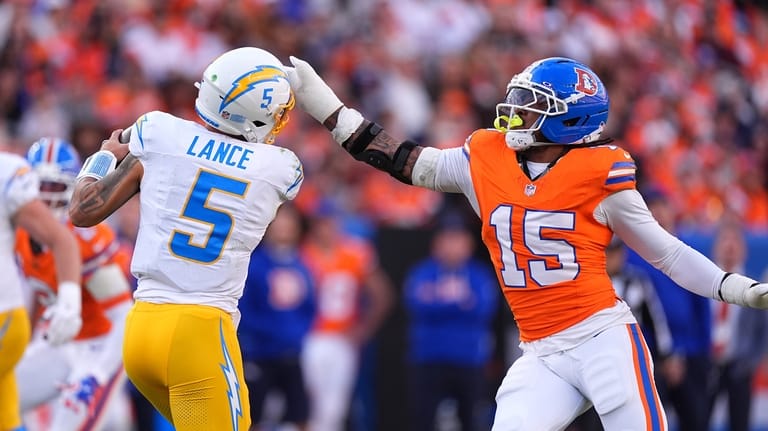 Denver Broncos linebacker Nik Bonitto (15) pressures Los Angeles Chargers...